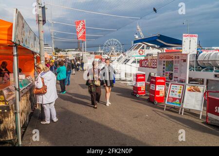 HELSINKI, FINLAND - AUGUST 25, 2016: People walk along stalls at Kauppatori Market Square in Helsinki Stock Photo