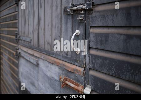 Perspective view of old rusty metal door with locks. Focused in foreground. Stock Photo