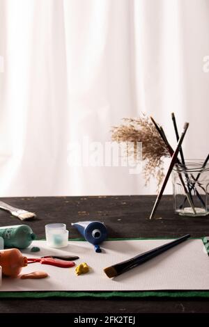 Paint spills with feather in jar Stock Photo