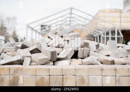 gray bricks and paving stones dismantled the sidewalk on the street Stock Photo