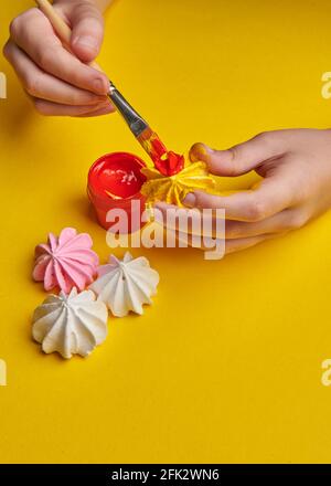 brush with paints on a yellow background Stock Photo