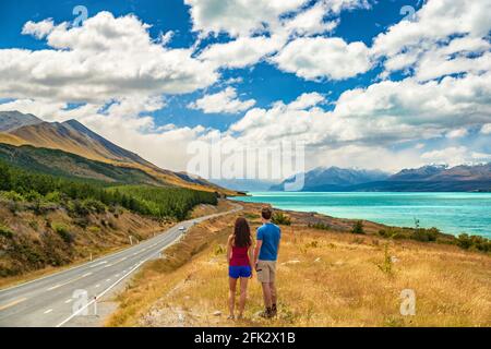 New Zealand travel - couple tourists looking at nature view of Aoraki aka Mount Cook at Peter's lookout, a famous tourist destination on New Zealand Stock Photo