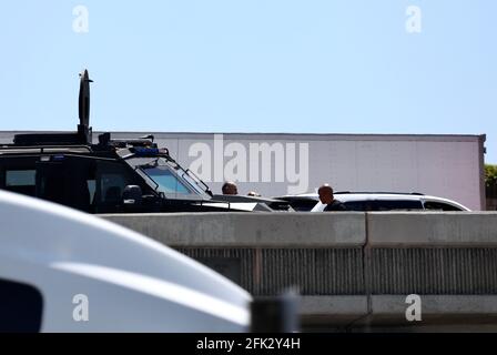 (210428) -- LOS ANGELES, April 28, 2021 (Xinhua) -- Police officers investigate at the scene where the gunman was killed in Fullerton shootout in Los Angeles, California, the United States, April 27, 2021. A gunman, suspected of killing two and wounding another in a series of drive-by shooting incidents in Los Angeles, was killed by police Tuesday morning after about five hours' chase and exchange of fire. According to Raul Jovel, an officer from the Los Angeles Police Department (LAPD)'s Media Relations Division, the shooter's rampage occurred from 0:55 a.m. to 1:25 a.m. local time, when Stock Photo