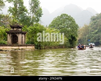 Huong Son, Vietnam - March 8, 2016: Tourist boats on the way to Perfume Pagoda, a popular day trip from Hanoi Stock Photo