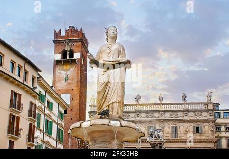 The ancient Roman sculpture of Madonna Verona Fountain with Gardello Tower and Palazzo Maffei in the background, Piazza Erbe square, Verona, Italy Stock Photo