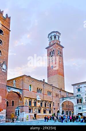 VERONA, ITALY - APRIL 23, 2012: Historic building of Palazzo della Ragione palace, topped with tall Lamberti Tower, Piazza dei Signori square, on Apri Stock Photo