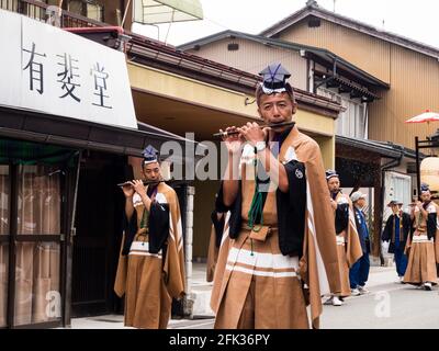 Takayama, Japan - October 10, 2015: Local performers in traditional costumes playing flute during Takayama Autumn Festival parade Stock Photo