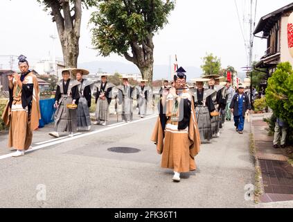 Takayama, Japan - October 10, 2015: Local people in traditional costumes marching the streets of historic Takayama during the annual Takayama Autumn F Stock Photo