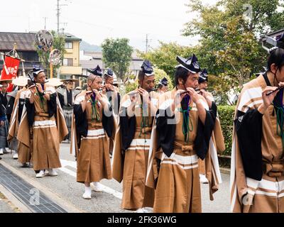 Takayama, Japan - October 10, 2015: Local performers in traditional costumes playing flute during Takayama Autumn Festival parade Stock Photo