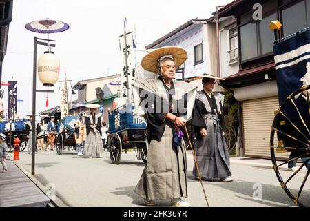 Takayama, Japan - October 10, 2015: Local people in traditional costumes marching the streets of historic Takayama during the annual Takayama Autumn F Stock Photo