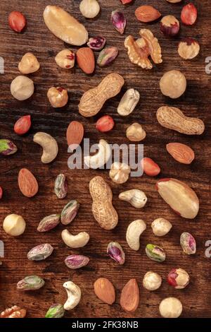 Nuts variety, top shot on a dark wooden background Stock Photo