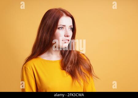 young woman with blank expression contemplating thought Stock Photo