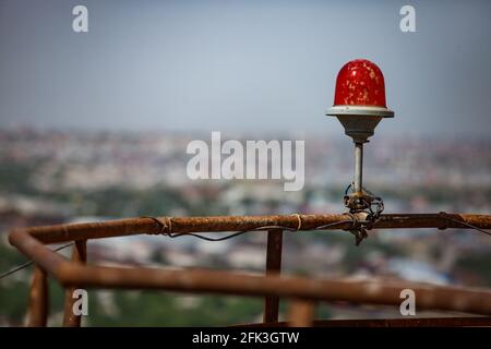 Aircrafts and airplanes warning red light signal lamp on building's roof. Stock Photo