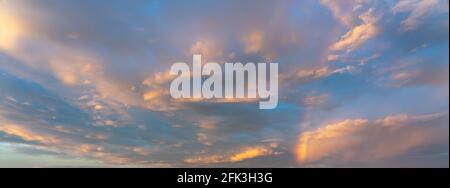 Dramatic sunset sky covered by gentle golden colored cloud  Stock Photo