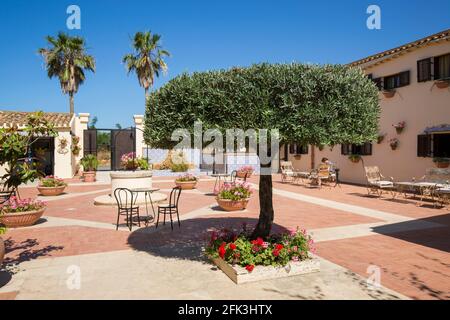 Agrigento, Sicily, Italy. View across sunlit courtyard of the historic Baglio della Luna boutique hotel. Stock Photo