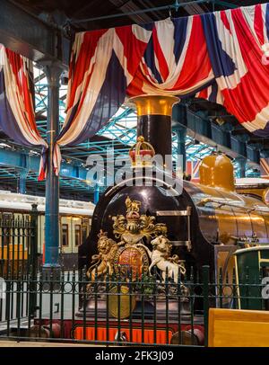 York, North Yorkshire, England. 1882 LB&SCR B1 Class steam locomotive, Gladstone, on display beneath Union Jacks at the National Railway Museum. Stock Photo