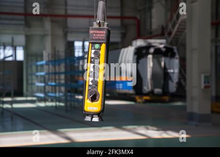 Nur-Sultan,Kazakhstan:Locomotive and train-building plant.Remote control Oritcranes for overhead crane in focus.Rail car Tulpar-Talgo blurred on bckgd Stock Photo