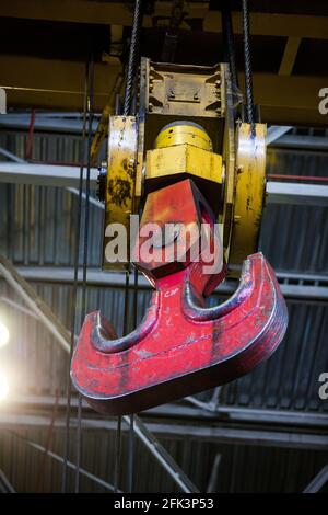 Abstact industrial background. Close-up photo of overhead crane hook. On factory or plant. Stock Photo