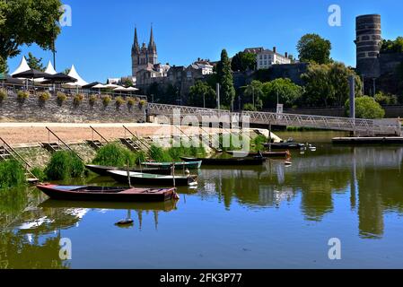 Little boats on the Maine river at Angers and the cathedral Saint Maurice in the background. Angers is a commune in the Maine-et-Loire in France Stock Photo