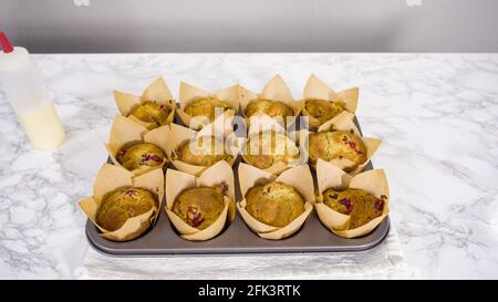 Step by step. Cooling freshly baked cranberry muffins. Stock Photo
