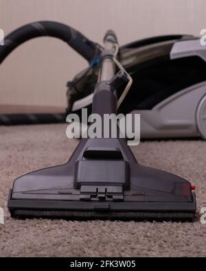 Vacuum cleaner black gray with a carpet cleaner. Washing vacuum cleaner. Cleaning the house.A close up of a toy. Stock Photo