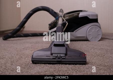 Vacuum cleaner black gray with a carpet cleaner. Washing vacuum cleaner. Cleaning the house.A close up of a toy. Stock Photo