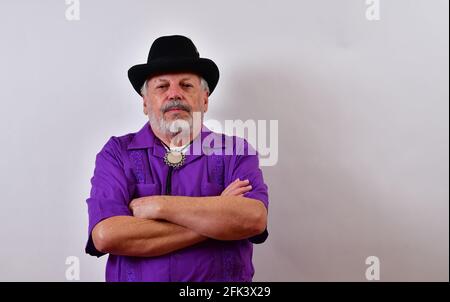 Serious senior man standing with his arms crossed Stock Photo