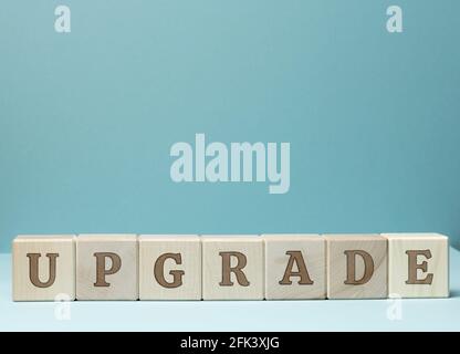inscription upgrade on wooden cubes. Updating and upgrading, improving programs and products. Updated version, blue background Stock Photo