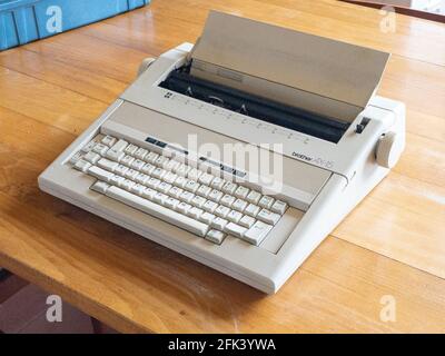 Antique electronic typewriter ready on a wood desk Stock Photo
