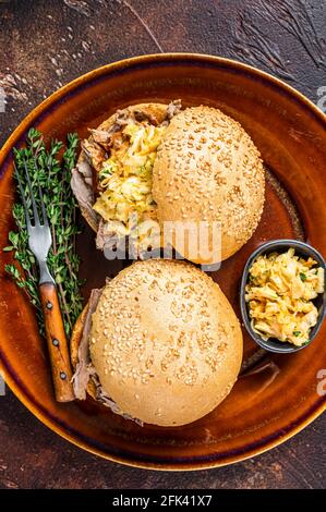 Pulled Pork meat Hamburger with coleslaw salad. Dark background. Top view Stock Photo
