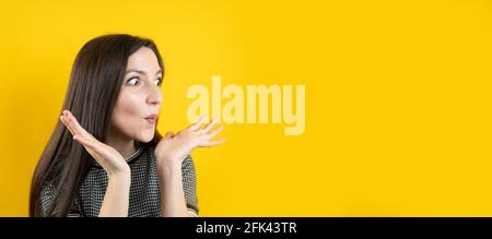 Banner of a surprised young girl, on a yellow background. Stock Photo