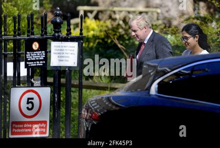 British Prime Minister Boris Johnson returning to 10 Downing Street with Munira Mirza (Director of the Number 10 Policy Unit) after a press briefing Stock Photo