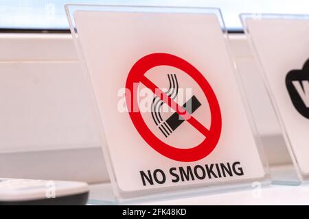 Close-up of the No smoking indoors sign on the windowsill Stock Photo