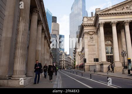 Commuters walk on in landmark City of London as Coronavirus restrictions start to ease and the economy start to pick up in London, England on April 27, 2021.  The Prime Minister Boris Johnson has set a road map on easing the restrictions. Stock Photo