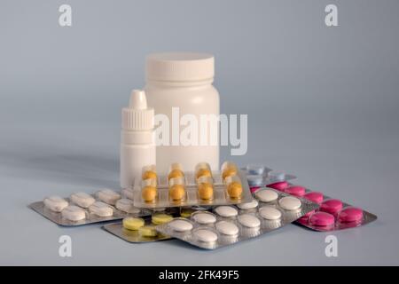 Different medicines- tablets and pills in blister pack, medications drugs and white plastic medical containers. Close-up. Copy space. Selective focus. Stock Photo