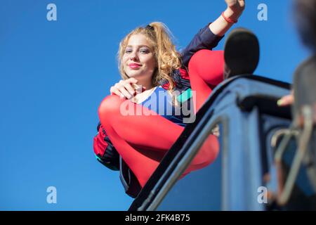 Beautiful girls in the style of the 90s in bright clothes against the blue sky. Stock Photo