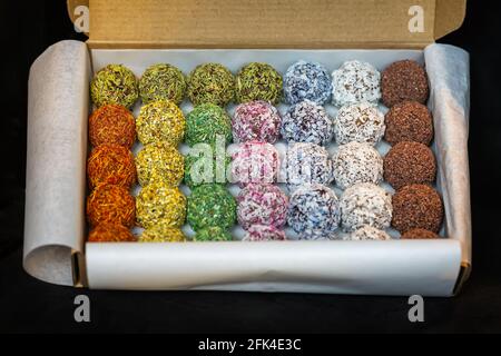 Box of Truffles with Chocolate and Rum top view. Coated in coconut and sprinkles, handmade Stock Photo