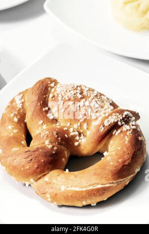 vegan dairy-free organic german traditional pretzel bread on white table Stock Photo