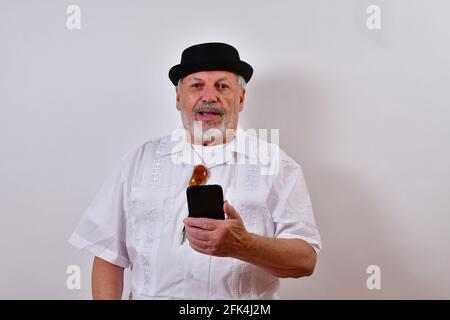 Senior man using his smartphone and smiling Stock Photo