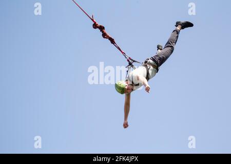 Rope Jumping. A man jumps from a bridge on a rope. Extreme sports. Stock Photo