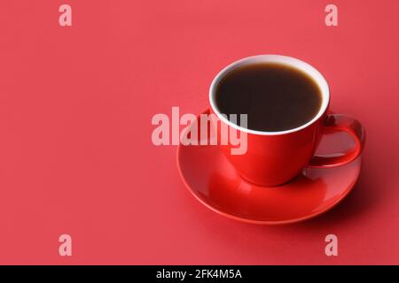Red cup of coffee on red monochrome background. Space for text. Stock Photo