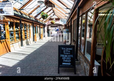 Interior of Great Torrington Pannier Market, Shops and Glass Roof Detail Looking Towards the Main Town Entrance and Torrington Square Stock Photo