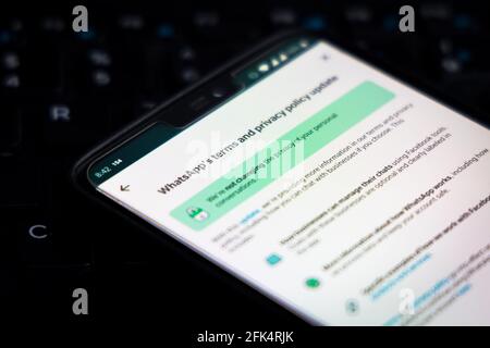 WhatsApp Terms of Service on a smartphone against a PC computer. Stock Photo