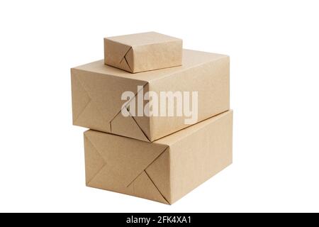 Closed brown cardboard boxes wrapped in kraft paper without label. Box for parcel, delivery or packaging isolated on white background. Stock Photo