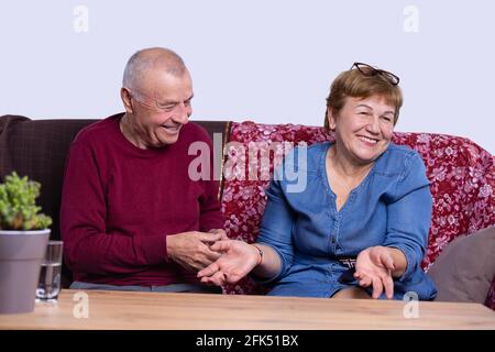 Happy senior couple in love hugging and bonding with true emotions at home. Stock Photo