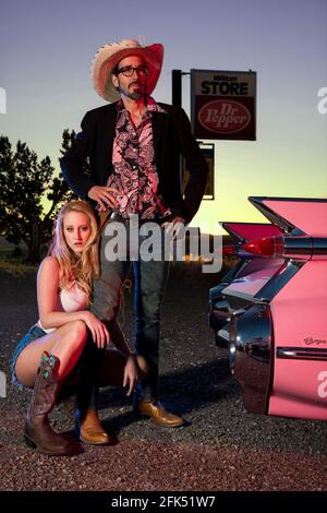 American Dreamscapes,Pink Cadillac, couple posing with Cadillac Stock Photo