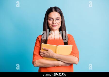 Photo of charming lady arms embrace book closed eyes eyewear isolated on pastel blue color background Stock Photo
