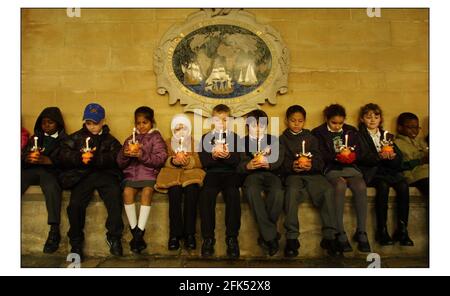 Children from St Barnabas Church of England school, Pimlico, getting ready to take part in the Childrens Societys annual Christingle celebrations at Westminster Abbey. This years theme is shine a Light on BullyingThe Orange symbolises the world,the red ribbon the blood of Christ and the candle the light of the world. pic David Sandison 28/11/2002 Stock Photo