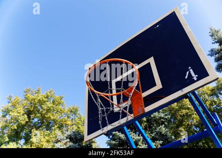 Old Basketball Hoop with Metal Chains on the Street or schoolyard Stock Photo