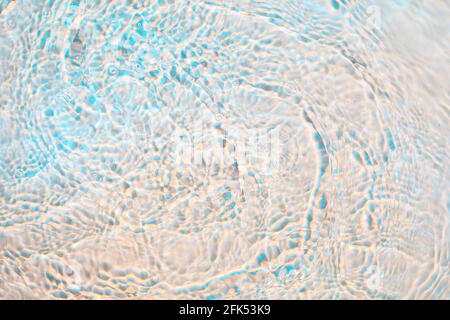 Light wavy with rainbow colors abstract rippled water texture background Stock Photo
